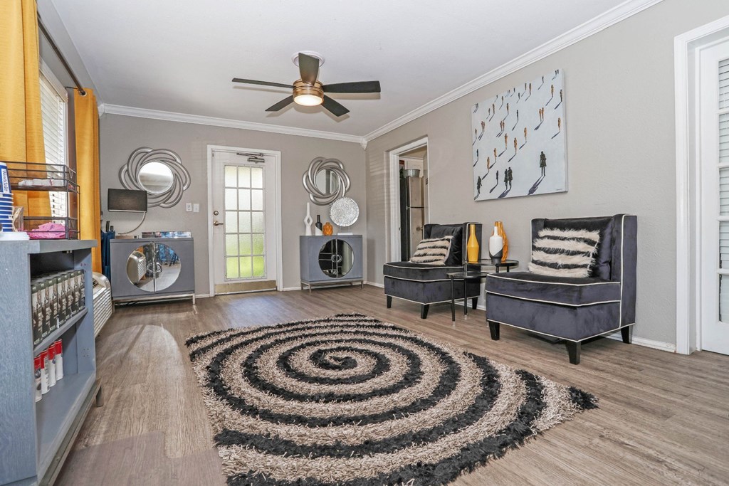 A leasing office with a black and white rug and a ceiling fan at Orleans Square in Shreveport, LA