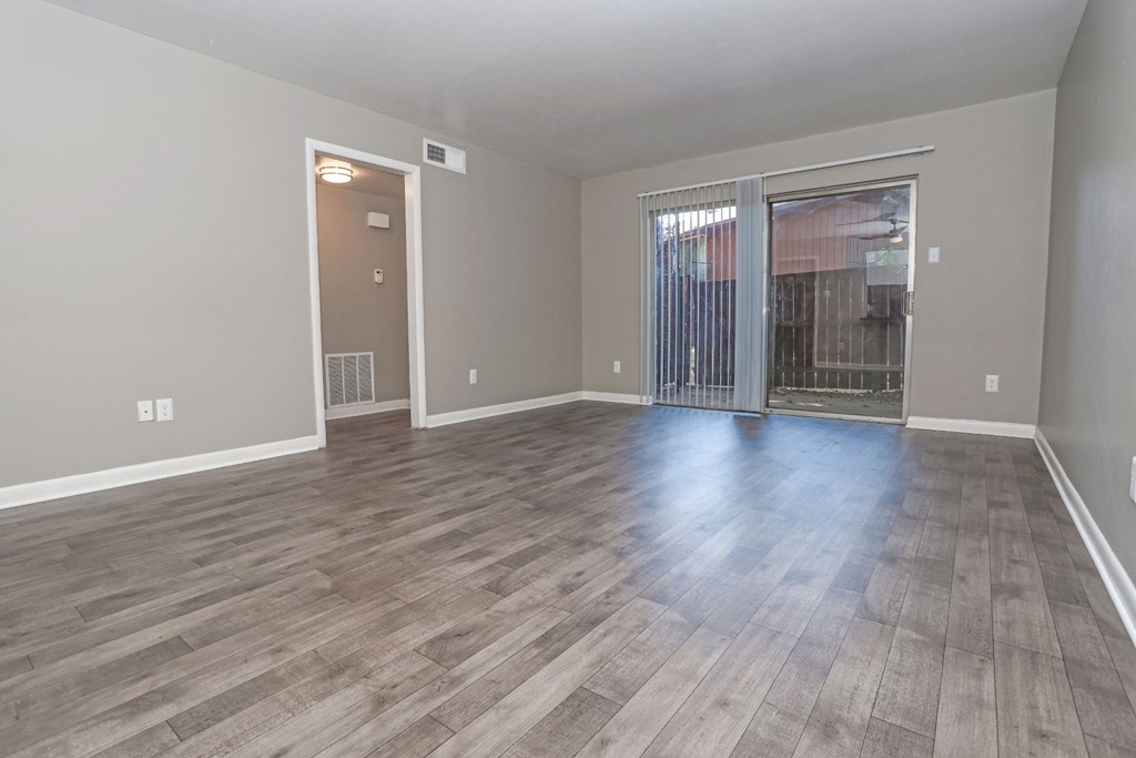 A room with wooden flooring and a sliding glass door at Orleans Square in Shreveport, LA