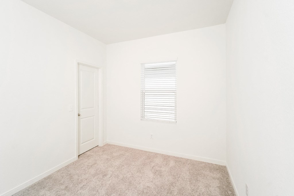 Oak bedroom with carpet and closet door at Beacon at Ashley River Landing in Summerville, SC