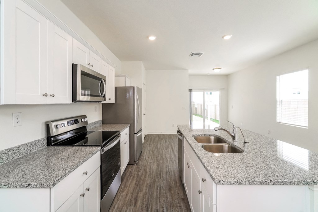 a kitchen with granite countertops and stainless steel appliances at Beacon at Meridian, San Antonio, TX 78245