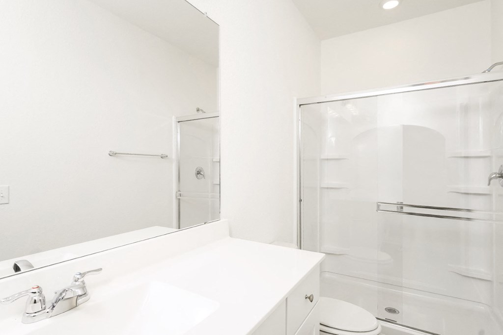 Oak master bathroom with a sink and a shower at Beacon at Ashley River Landing in Summerville, SC