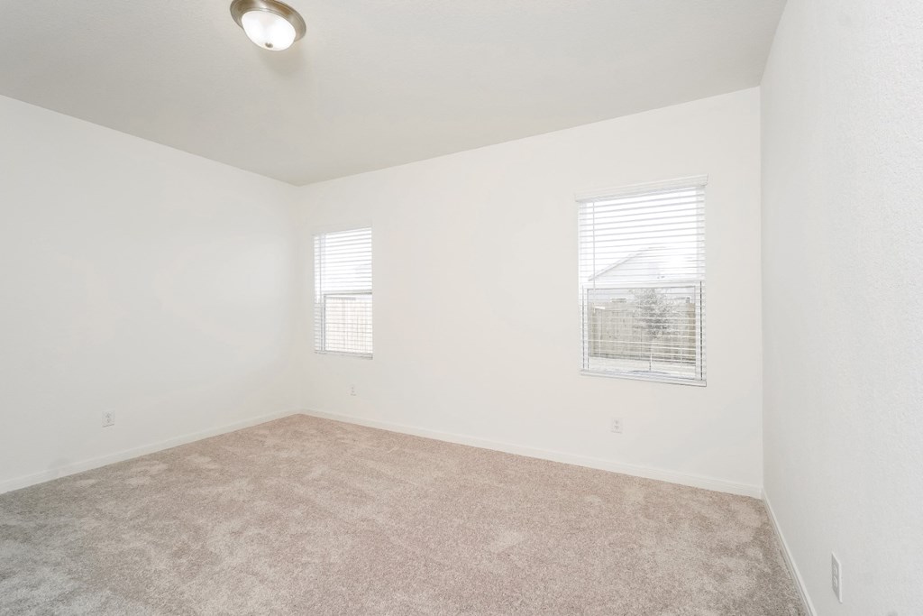 a bedroom with white walls and carpet at Beacon at Meridian, San Antonio, TX