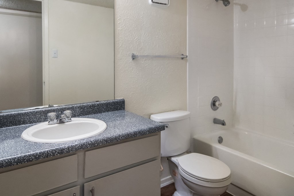 an empty bathroom with a sink toilet and shower
