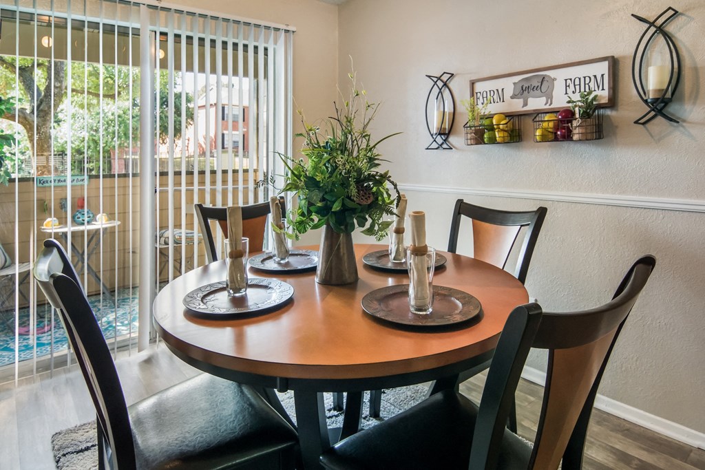a dining room with a table and chairs and a window