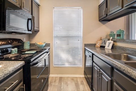 the preserve at ballantyne commons kitchen with stainless steel appliances and granite counter tops