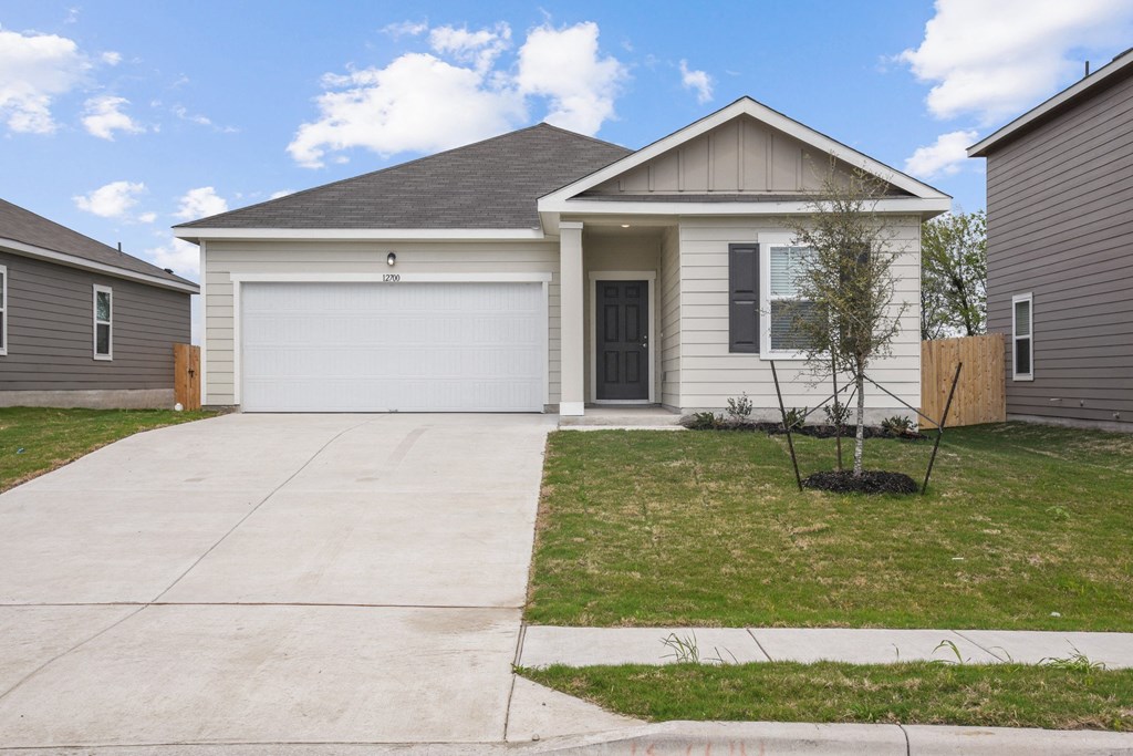 a home with a gray siding and a gray garage door at Beacon at Presidential Heights, Texas, 78653
