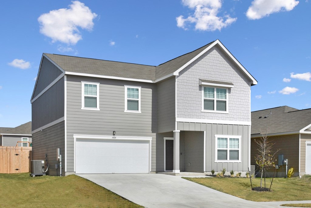 a house with a gray siding and a white garage door at Beacon at Presidential Heights, Manor