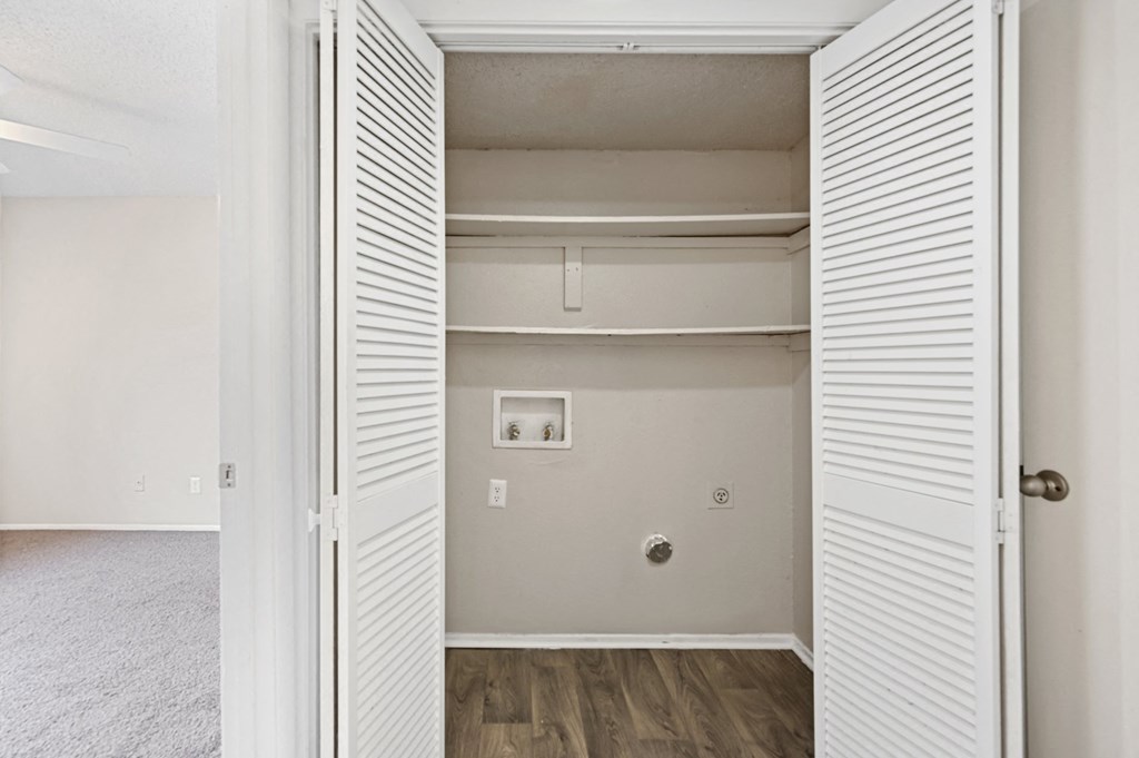 a bedroom with a medium sized closet and hardwood floors