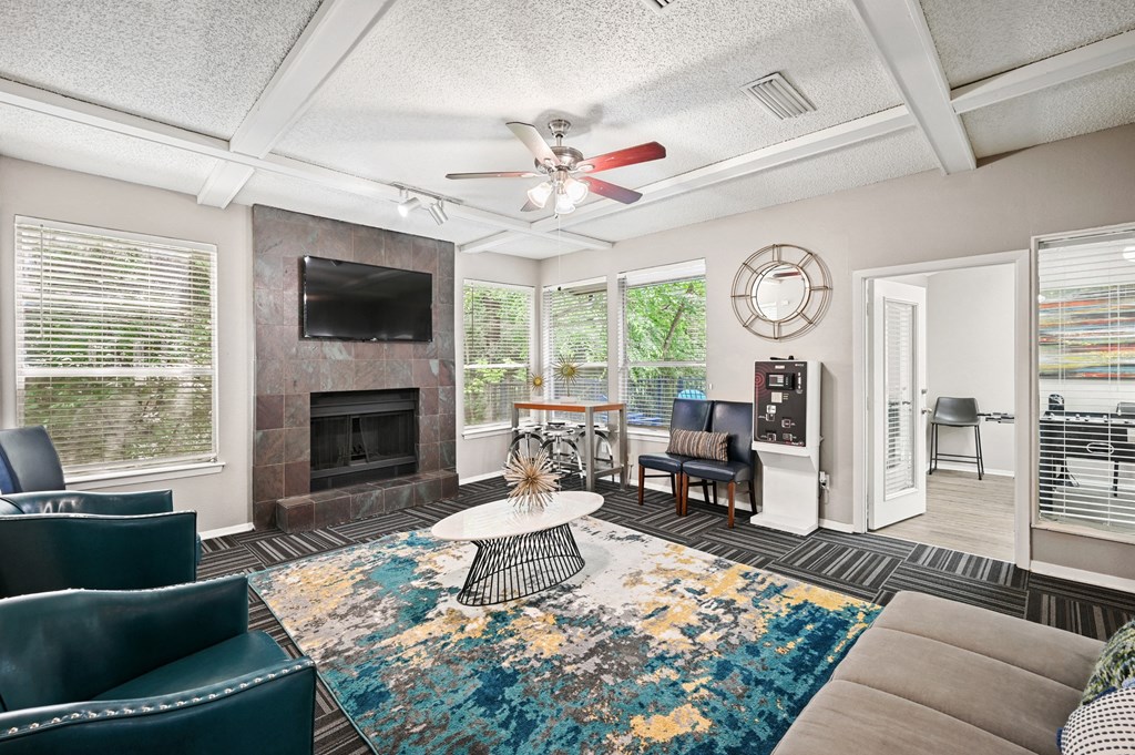 a living room with a fireplace and a ceiling fan