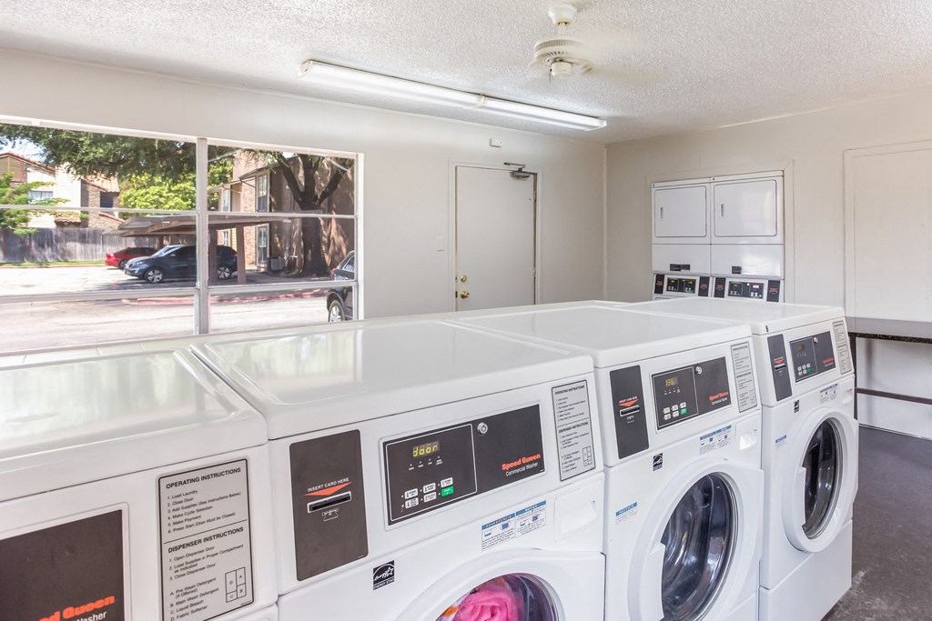 A laundry center at Preston Oaks Apartments in Dallas, Texas