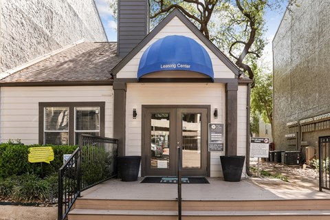 A leasing office with a blue awning that says Leasing Center at The Park on Preston in Dallas, TX