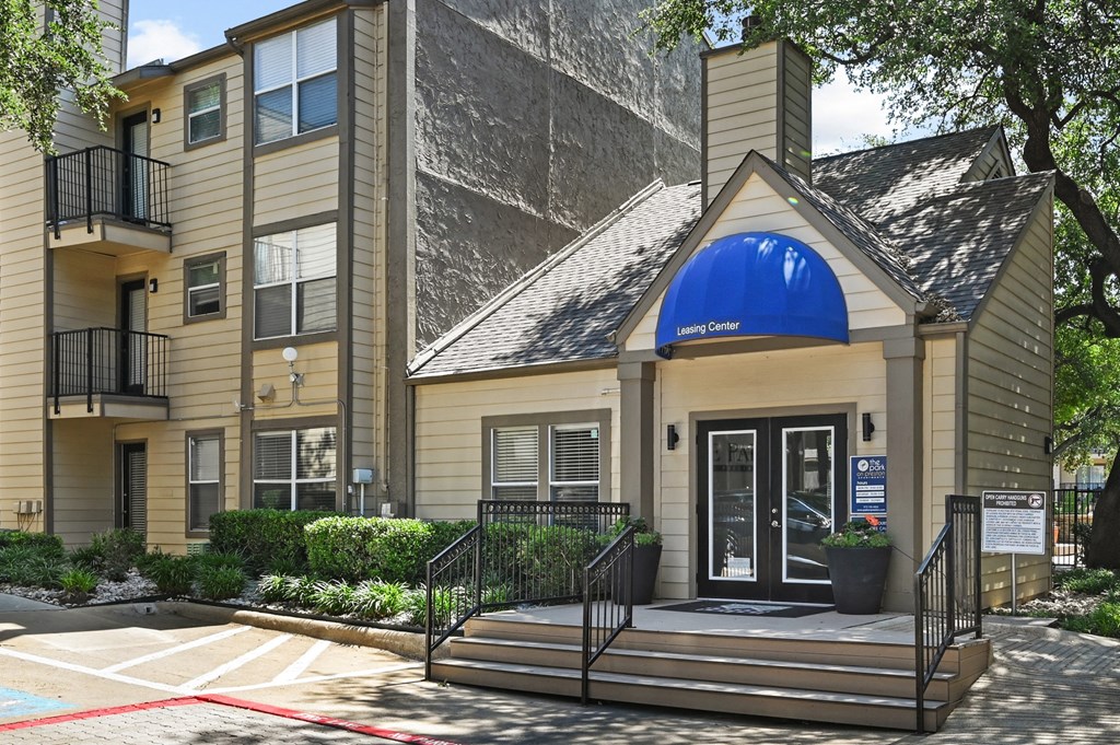 a building with a blue awning and stairs in front of it