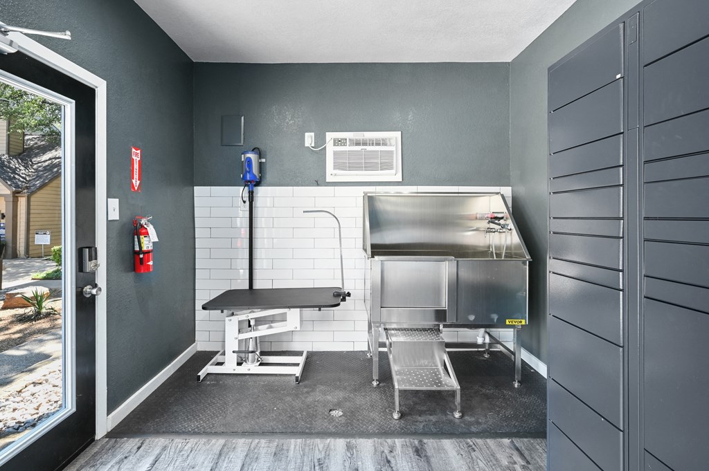 a kitchenette with a grill and a table and chairs
