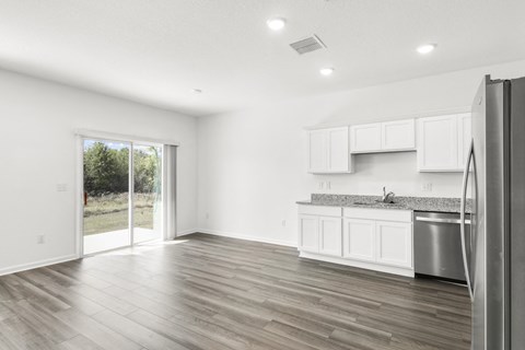 living room with a big window and white cabinets