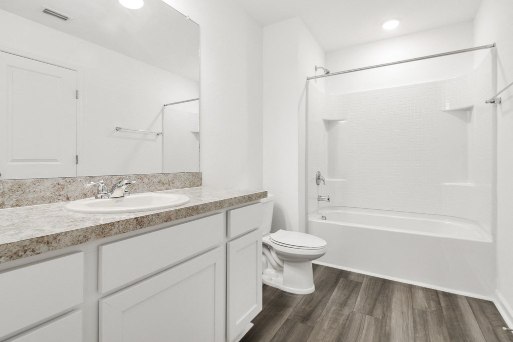 a bathroom with a bathtub and a sink