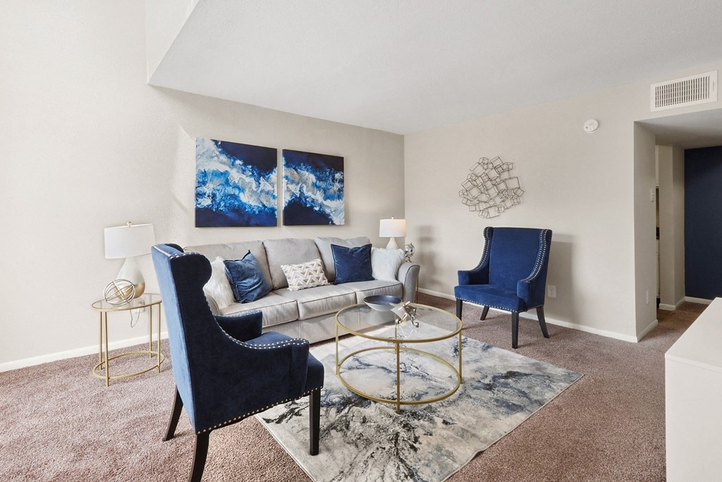 a living room with a couch and two chairs