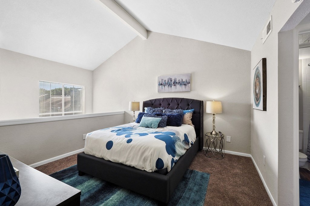 a bedroom with a bed and a window