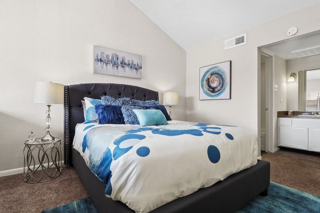 a bedroom with a bed and a mirror