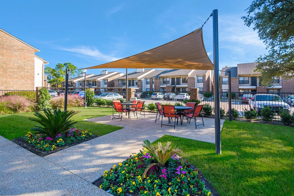 a patio with a table and chairs under a canopy