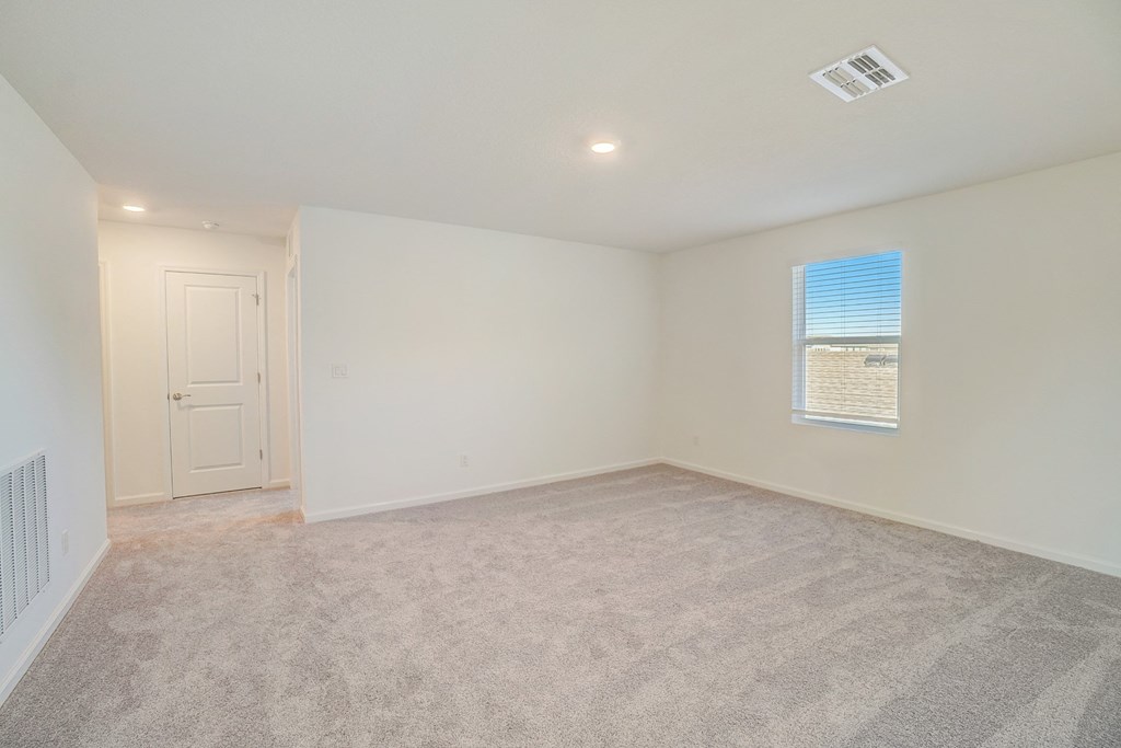 an empty living room with white walls and a window