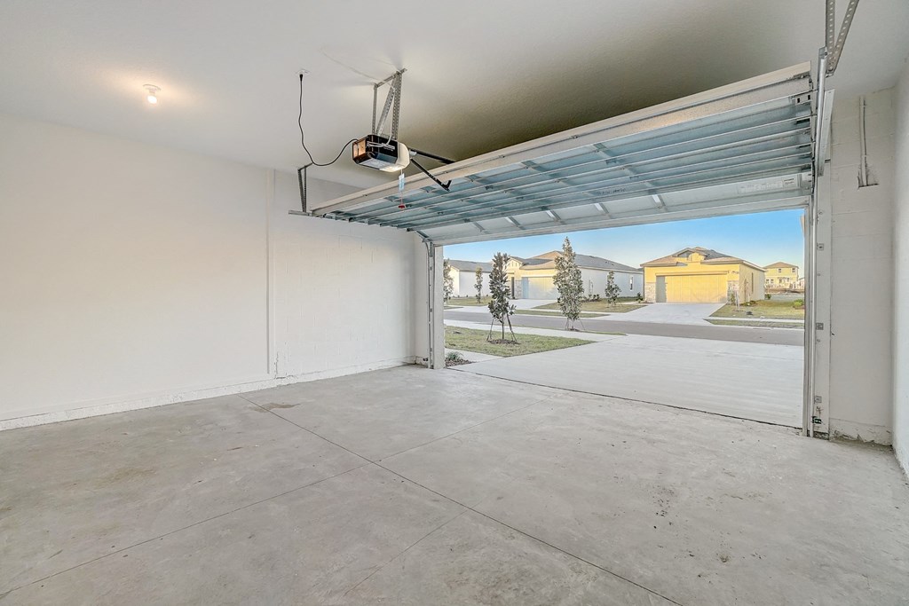 the interior of a garage with an open garage door