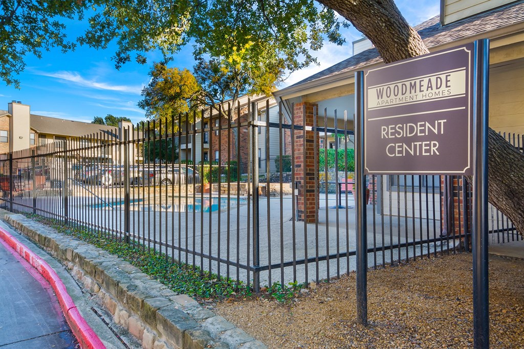 a wrought iron fence with a sign outside of a residential center