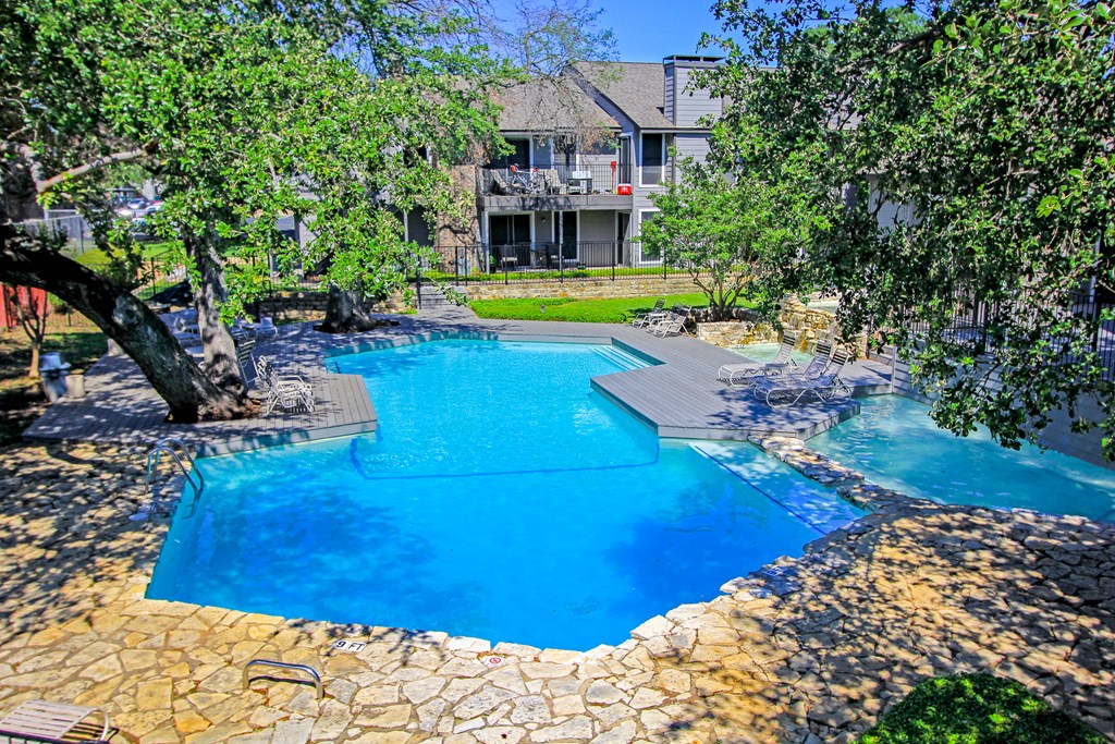 the pool surrounded by trees at Westdale Parke in Austin, TX