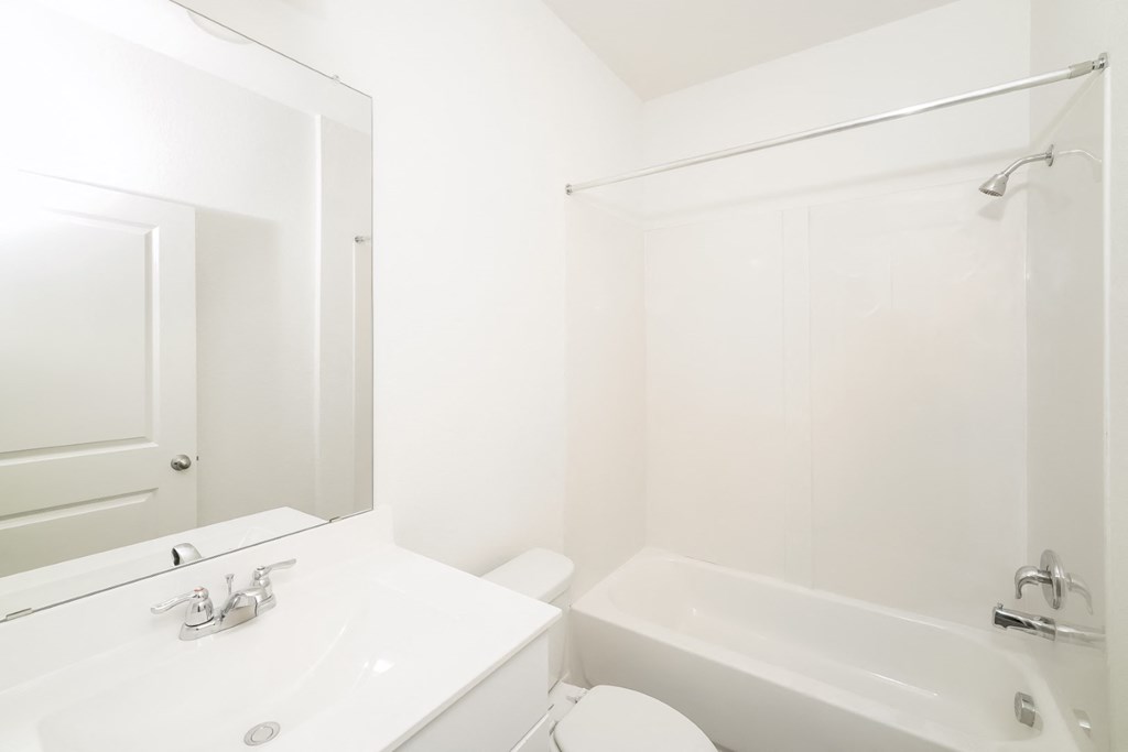 a bathroom with a sink toilet and bathtub at Beacon at Meridian, Texas