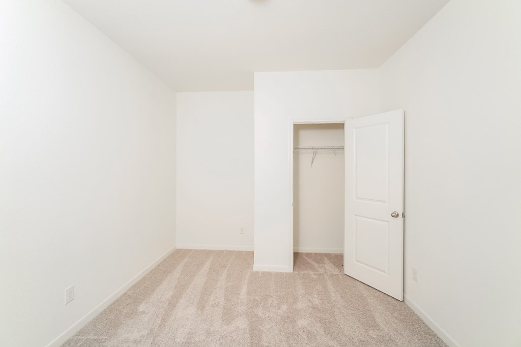 a bedroom with white walls and carpet at Beacon at Meridian, San Antonio Texas