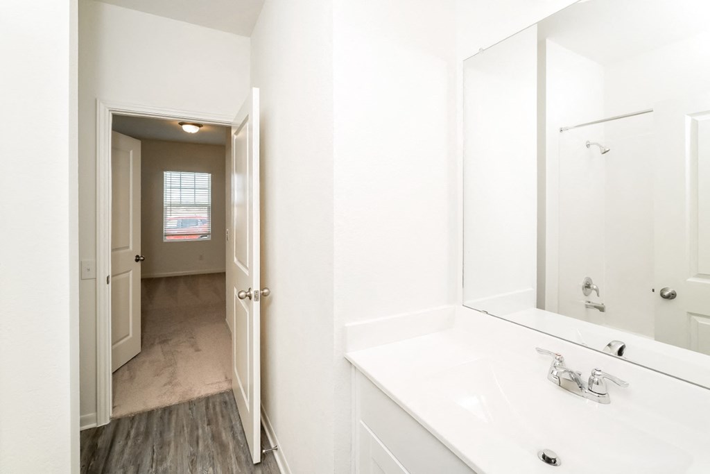 a bathroom with a sink and a mirror at Beacon at Meridian, San Antonio