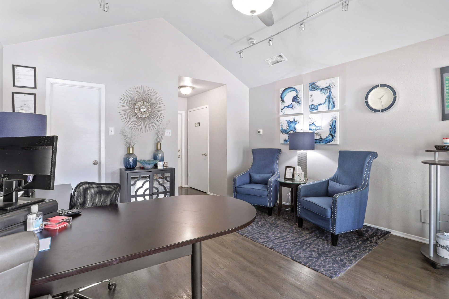 a living room with a table and chairs and a television
