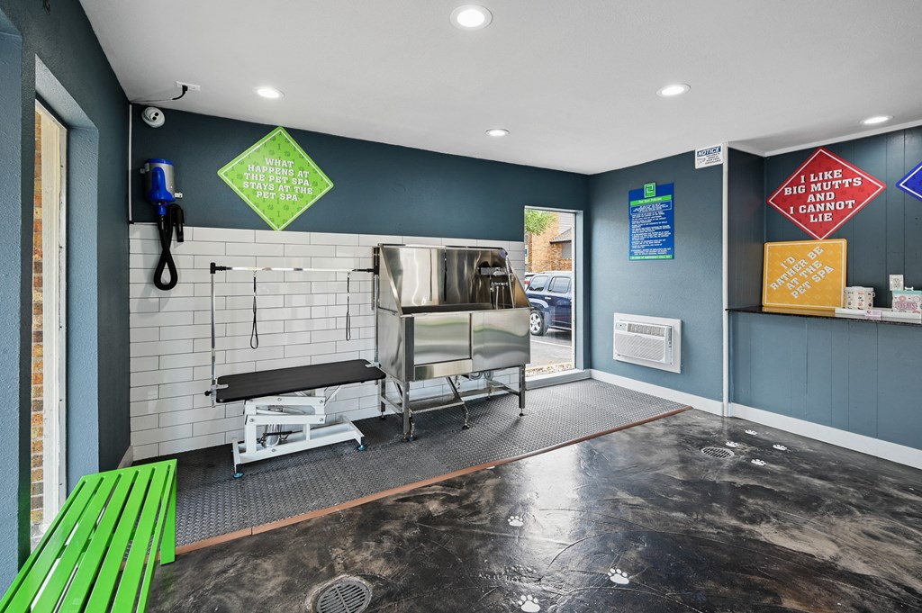 a kitchenette with a bar and a green bench in front of a door