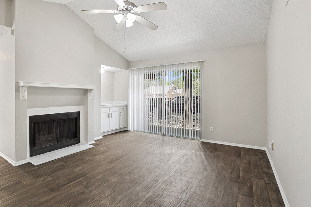 a living room with a fireplace and a large window