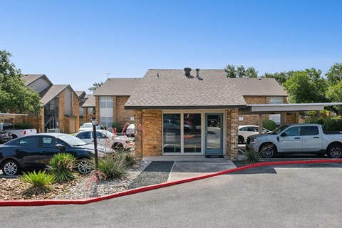 A building with a red border around it and cars parked in front.