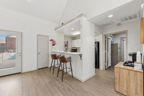 A kitchen area with a dining table and chairs.
