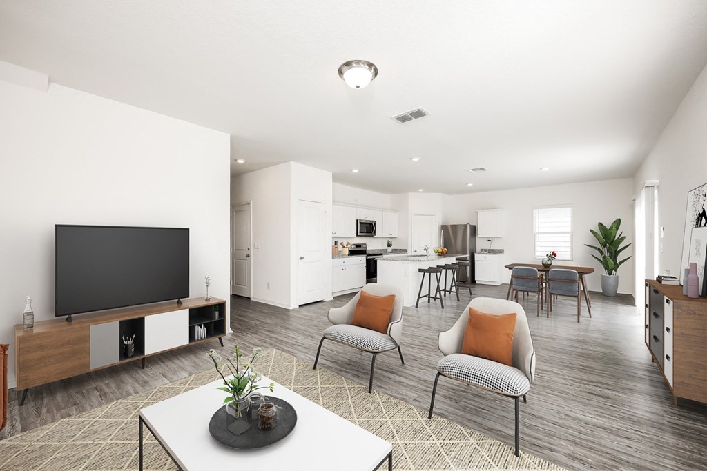 a living room and kitchen area with white walls and wood flooring at Beacon at Meridian, San Antonio Texas