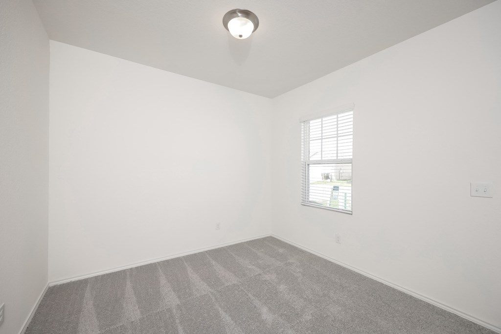 a bedroom with white walls and a window at Beacon at Meridian, San Antonio Texas