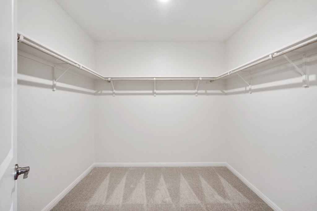 an empty room with white walls and carpet