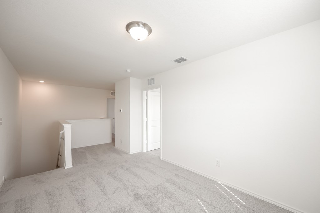 a bedroom with white walls and carpet  at Beacon at Meridian, San Antonio, TX 78245
