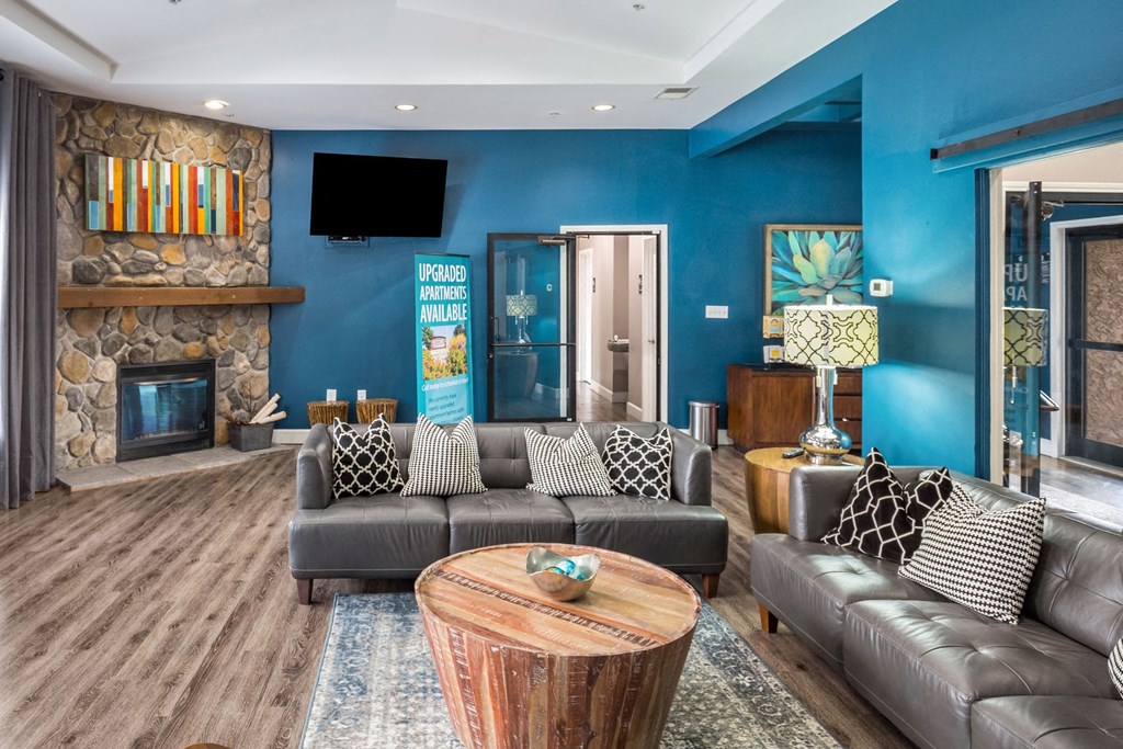 a living room with blue walls and a fireplace