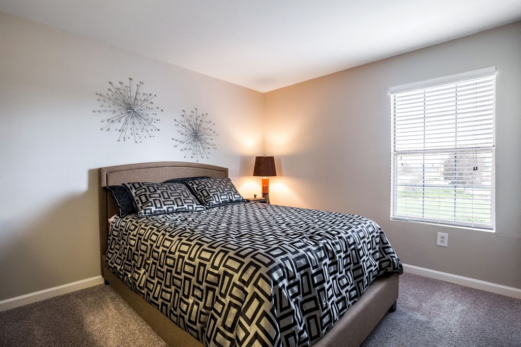 a bedroom with a bed and a window