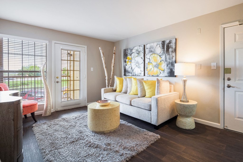 a living room with a couch and a door to a patio