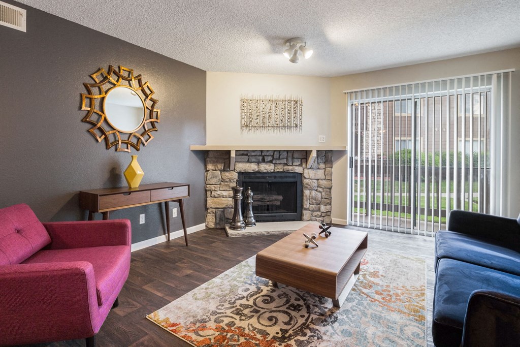 a living room with a fireplace and a couch and a table