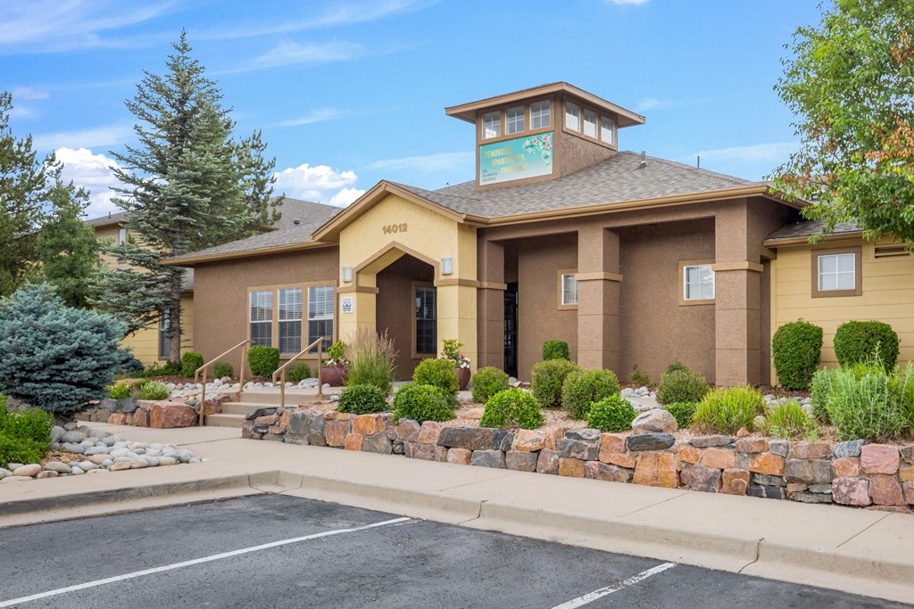 the front of a house with a driveway and a parking lot