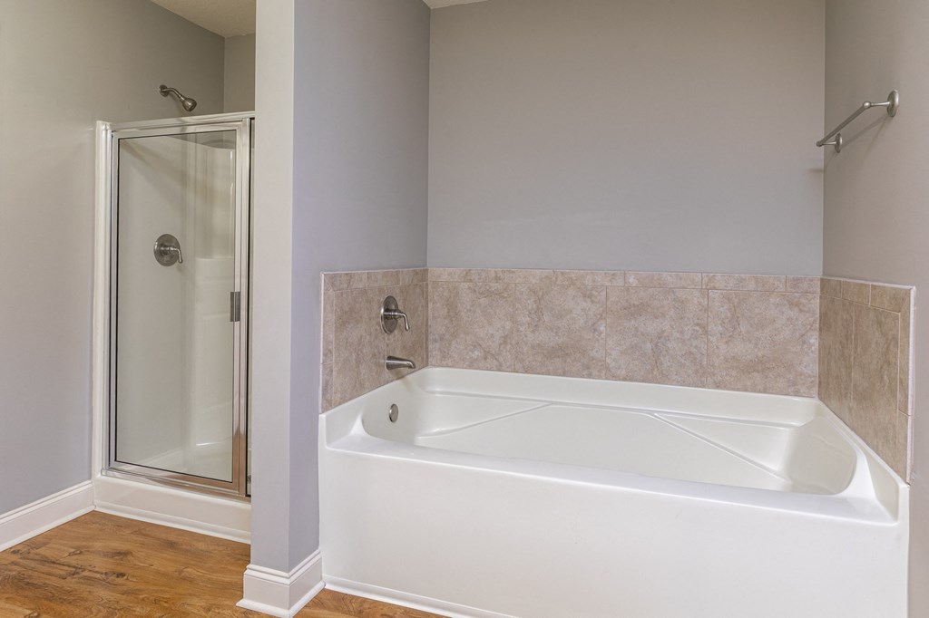 a bathroom with a tub and a shower