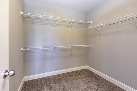 spacious walk in closets with shelves and hooks