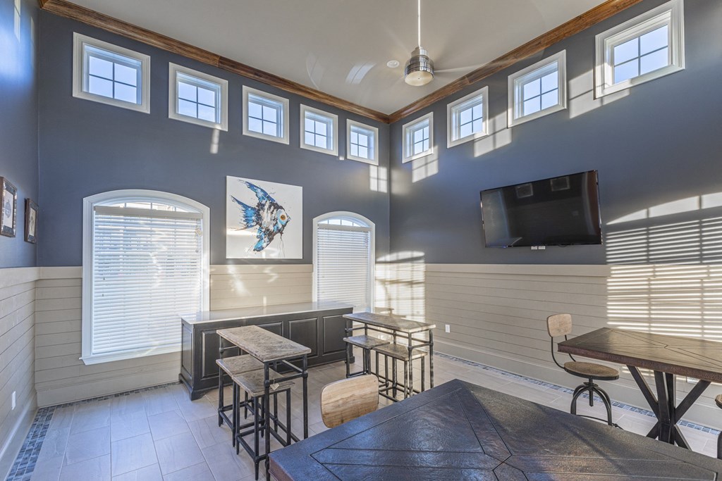 a living room with a table and chairs and a tv