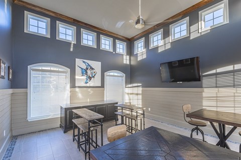 a living room with a table and chairs and a tv