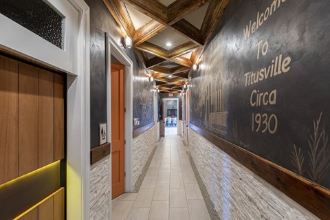 a hallway with a large blackboard on the wall and doors