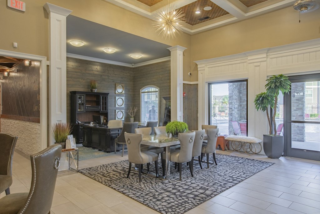 a dining room with a table and chairs in front of a window